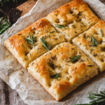 Focaccia Bread What to Eat It With for Easy, Cozy Meals 8 Sliced focaccia bread with rosemary on parchment